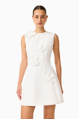 Brunette model wearing the Reina Applique Mini Dress Dress White close up shot