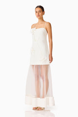 Brunette model wearing the Reina Appliqué Gown in White side shot