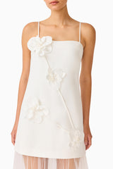 Brunette model wearing the Reina Appliqué Gown in White detail shot