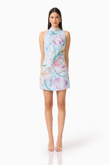 Brunette model wearing the Priselle High Neck Mini Dress in Blue Floral front shot