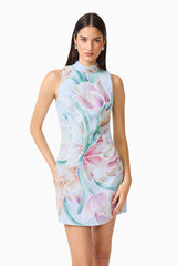 Brunette model wearing the Priselle High Neck Mini Dress in Blue Floral hand on hip shot