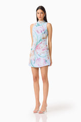 Brunette model wearing the Priselle High Neck Mini Dress in Blue Floral side shot