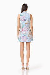 Brunette model wearing the Priselle High Neck Mini Dress in Blue Floral back shot