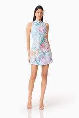 Brunette model wearing the Priselle High Neck Mini Dress in Blue Floral posed shot