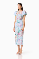 Brunette model wears the Priselle Puff Sleeve Midi Dress in Blue Floral side shot