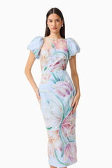 Brunette model wears the Priselle Puff Sleeve Midi Dress in Blue Floral close up shot