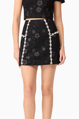 Blonde model wearing Ellouise Embellished Tweed Set in Black skirt detail shot