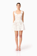 Brunette model wearing Margot Floral Mini Dress in White front shot