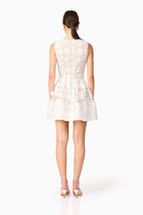 Brunette model wearing Margot Floral Mini Dress in White back shot