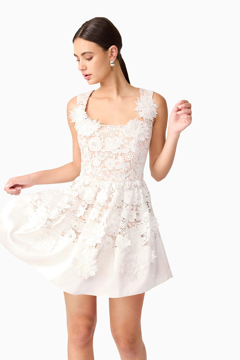 Brunette model wearing Margot Floral Mini Dress in White close up shot