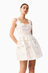 Brunette model wearing Margot Floral Mini Dress in White side shot
