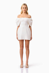 Blonde model wearing Fiona Off The Shoulder Mini Dress in White front shot