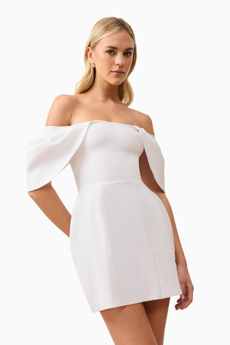 Blonde model wearing Fiona Off The Shoulder Mini Dress in White close up posed shot