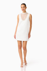 Espera Shift Mini Dress in White with collared neckline & front sheer pearl panel posed shot