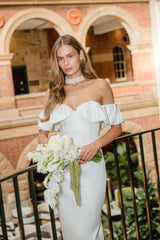 Model wears Espera Off Shoulder Midi Dress in White to engagement party 