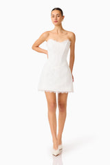 Clarisse Tulip Mini Dress in White with corset bodice & lace trim posed shot