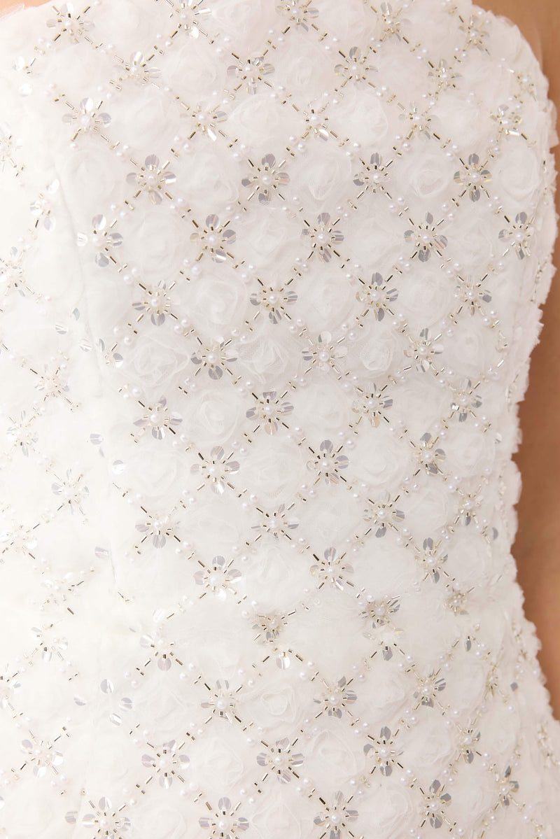 Blonde model wearing Lola Strapless Mini Dress in White detail shot