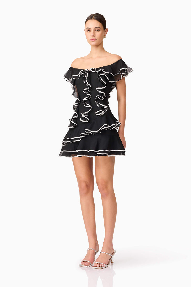 Brunette model wearing Melissa Tiered Mini Dress in Black side shot