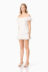 Blonde model wearing Melissa Tiered Mini Dress in White side shot