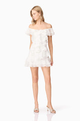 Blonde model wearing Melissa Tiered Mini Dress in White posed shot