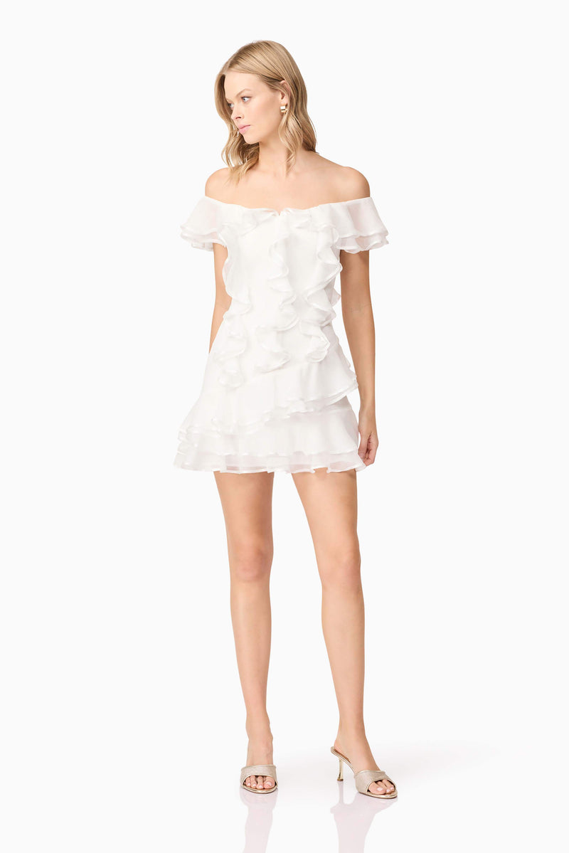 Blonde model wearing Melissa Tiered Mini Dress in White posed shot
