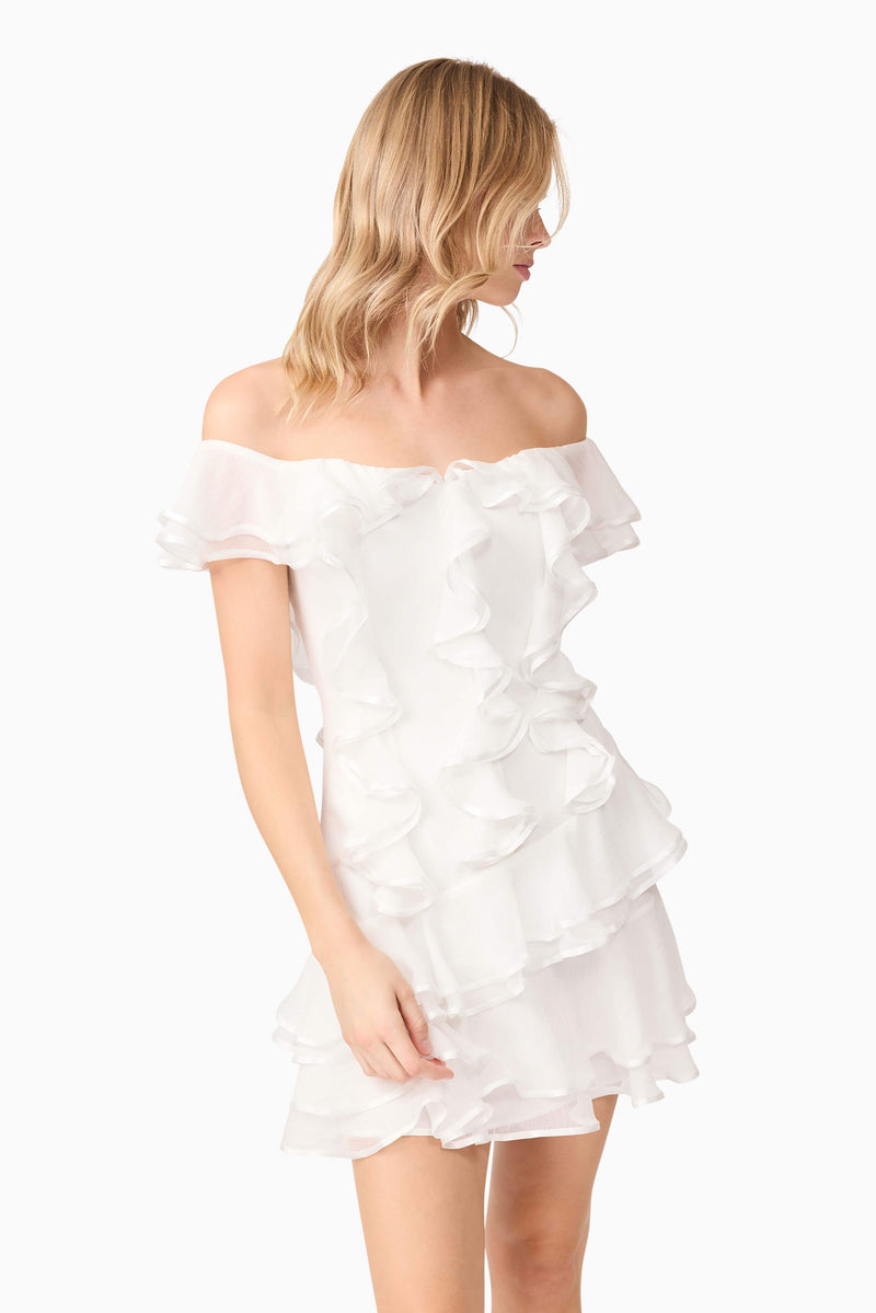 Blonde model wearing Melissa Tiered Mini Dress in White close up shot