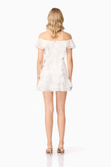 Blonde model wearing Melissa Tiered Mini Dress in White back shot