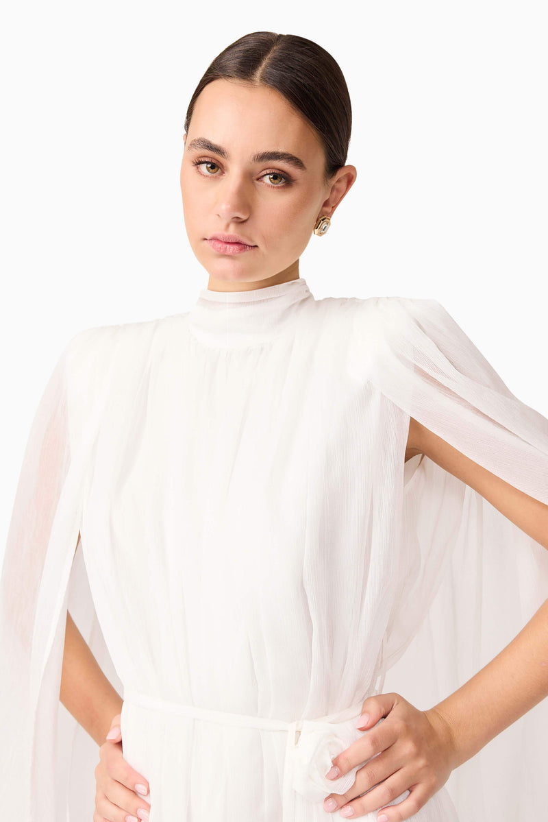 Brunette model wearing Melisa Long Sleeve Gown in White detail posed shot shot