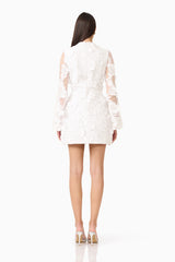 Lorina Flared Sleeve Mini Dress in White  with zipper back & sheer long sleeves with 3d floral appliques back shot 