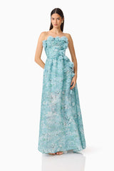 Brunette model wearing the Faye Strapless Gown in Blue posed shot