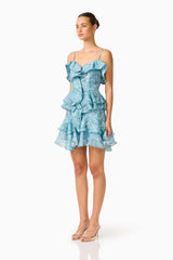 Brunette model wearing the Faye Mini Dress in Blue side shot