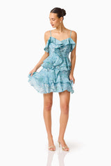 Brunette model wearing the Faye Mini Dress in Blue posed shot