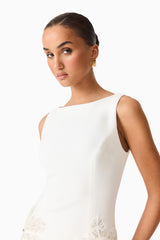 Brunette model wearing the Skye Mini Dress in White close up top shot