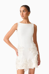 Brunette model wearing the Skye Mini Dress in White close full shot