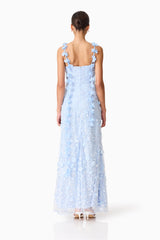 Brunette model wearing the Rina Embellished Gown in Blue back shot