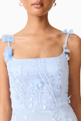 Brunette model wearing the Rina Embellished Gown in Blue top close up shot