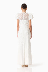Brunette model wearing the Rina Puff Sleeve Gown in White back shot