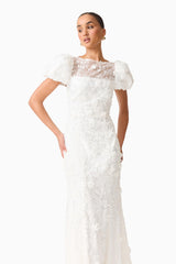 Brunette model wearing the Rina Puff Sleeve Gown in White front posed shot