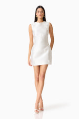 Brunette model wearing the Tula Shift Mini Dress in White posed shot