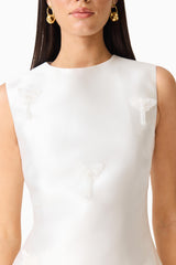 Brunette model wearing the Tula Shift Mini Dress in White detailed shot