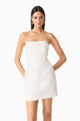 Brunette model wearing the Daelia Strapless Mini Dress in White posed shot