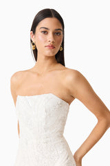 Brunette model wearing the Daelia Strapless Mini Dress in White side posed shot