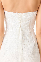 Brunette model wearing the Daelia Strapless Mini Dress in White back close up shot