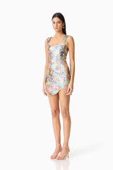 Brunette model wearing the Athea Mini in Floral side shot