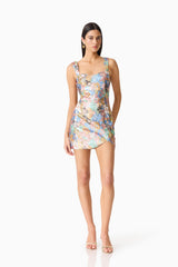 Brunette model wearing the Athea Mini in Floral posed shot