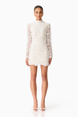Brunette model wearing the Cora Long Sleeve Mini Dress in White front shot