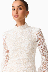 Brunette model wearing the Cora Long Sleeve Mini Dress in White close up shot