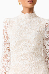 Brunette model wearing the Cora Long Sleeve Mini Dress in White detailed shot