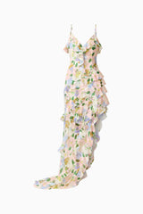 Brunette model wearing the Cosima Asymmetrical Gown In Florals ghost shot 