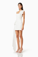 Brunette model wearing Janelle Party Mini Dress In White side shot